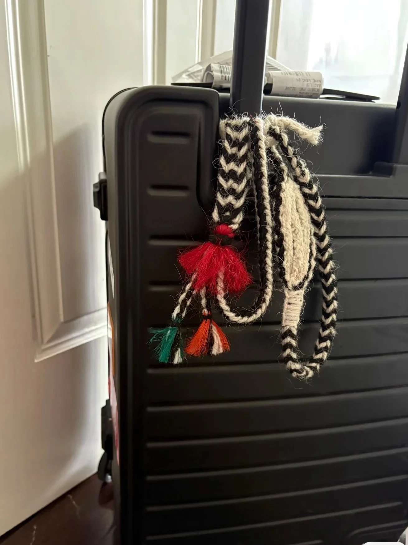 The Original Wurdoo hanging on a suitcase handle